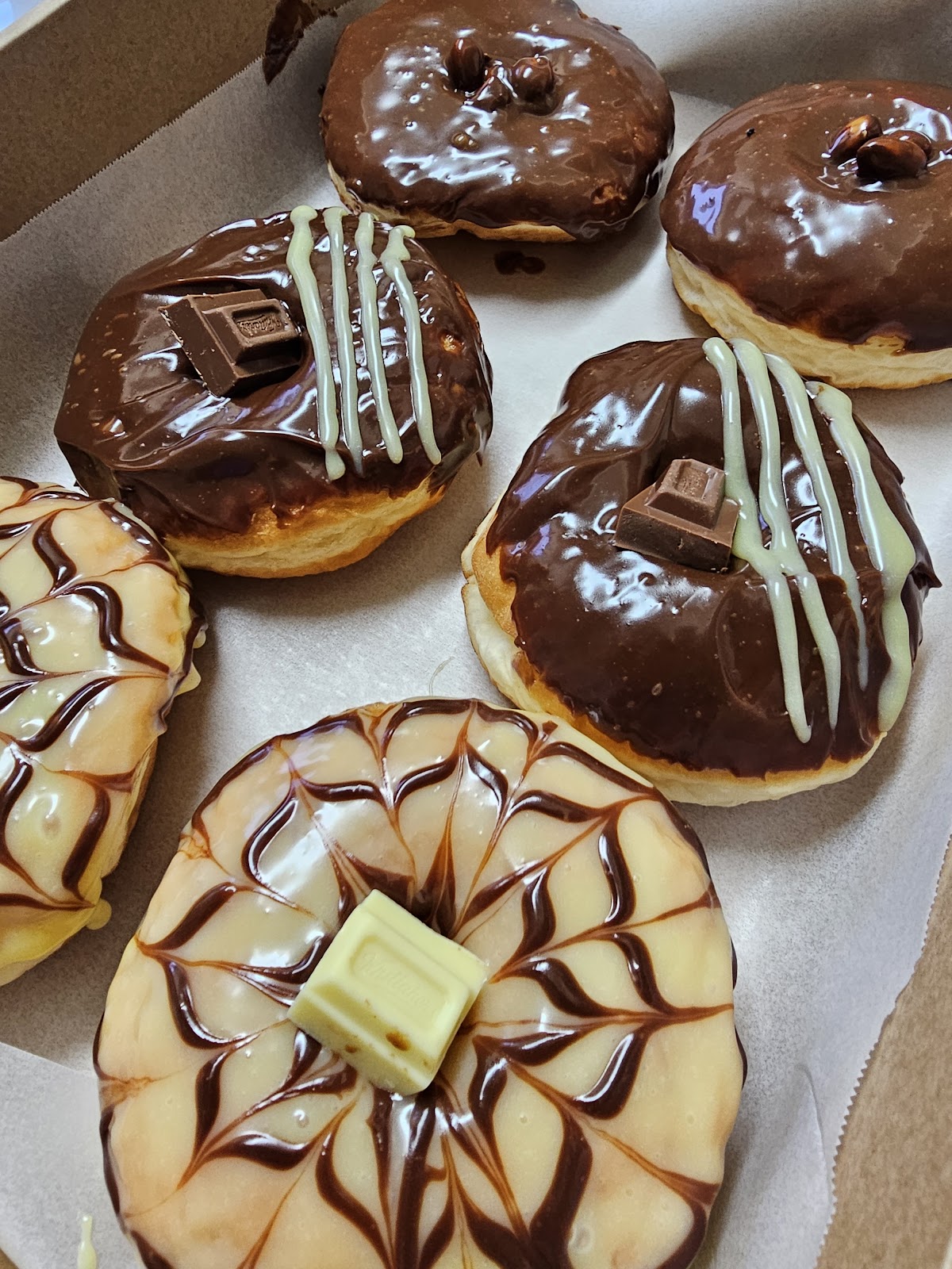 Box of chocolate topped Whittaker's donuts
