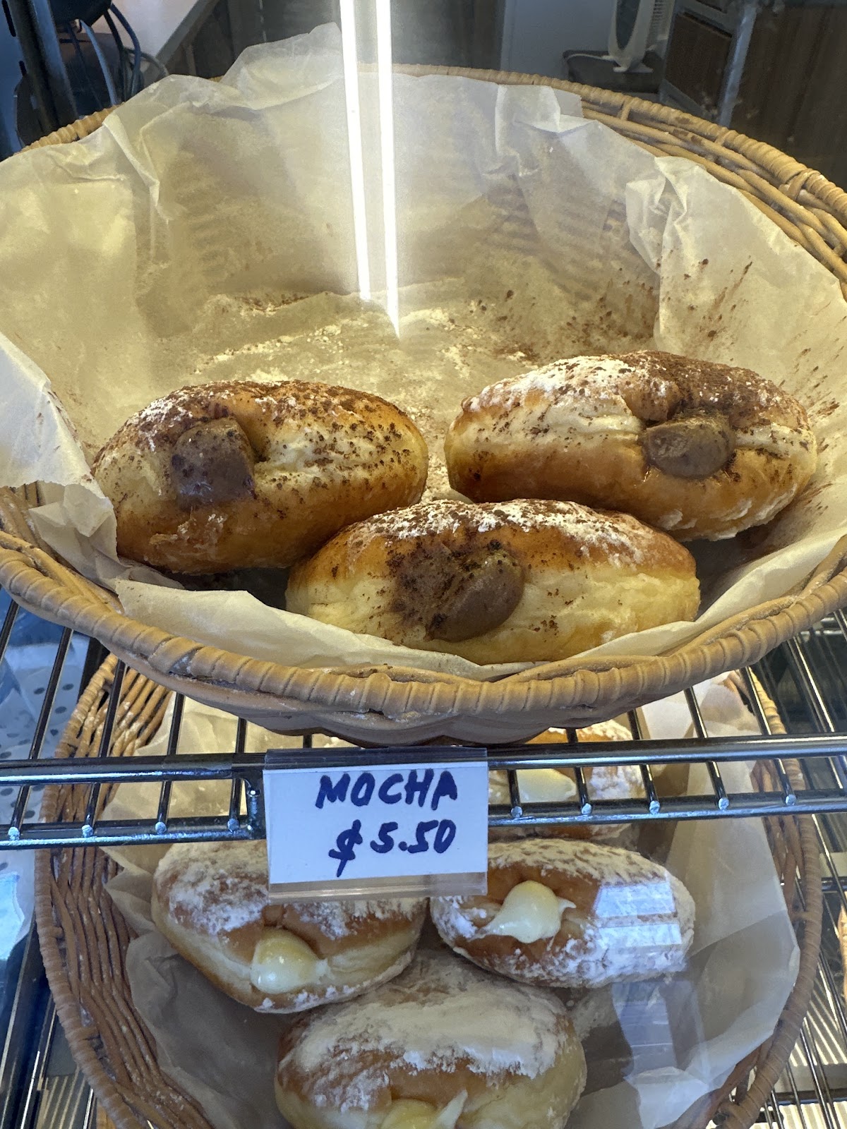 Basket of mocha filled donuts in the display cabinet